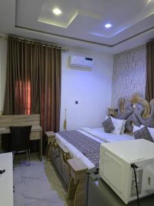 a hotel room with a bed and a desk and a desk at Single Room in Abuja