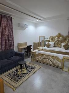 a bedroom with a large bed and a couch at Single Room in Abuja