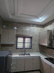 a kitchen with a sink and a window at Single Room in Abuja