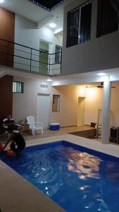 a man in a swimming pool in a house at Casa Tania playa larga in Agua de Correa
