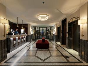 a lobby with a red couch in the middle at The One Monumental Palace in Porto +92 photos