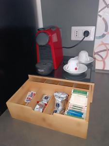 a wooden box with books and a red printer at L'angolo di Cinzia in Matera