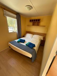 a bedroom with a bed with two blue pillows on it at La Finquilla Holidays in Estepona +27 photos