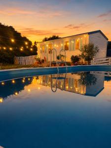 a pool with a swing in front of a house at La Finquilla Holidays in Estepona