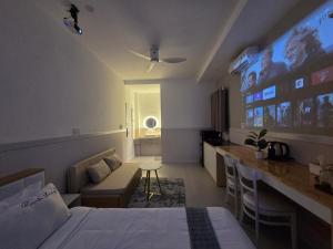 a hotel room with a bed and a bar at 1001 Stars Hotel in Ho Chi Minh City