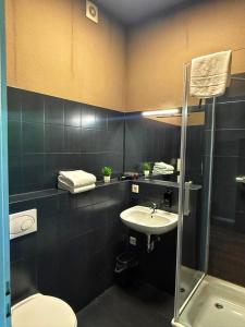 a bathroom with a sink and a toilet and a shower at N8 Rooms by BW Living in Leipzig +18 photos