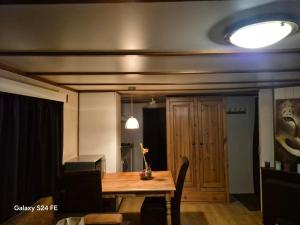 a dining room with a table and a light at Chalet te huur op Camping de Kleine Wielen te Leeuwarden in Leeuwarden