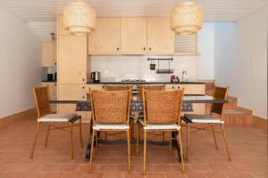 a dining room with a table and chairs in a kitchen at Casa do Lagar by Quinta de Recião in Lamego