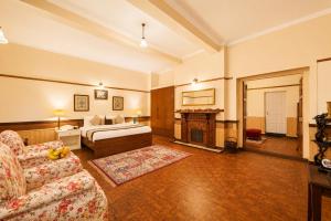 a living room with a bed and a couch at Springfields - A Heritage Palace Since 1902 by Eastlynn Experiences in Shimla