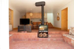 a living room with a brick fireplace in a house at Casa do Lagar by Quinta de Recião in Lamego