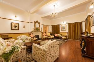 a living room with couches and a fireplace at Springfields - A Heritage Palace Since 1902 by Eastlynn Experiences in Shimla +21 photos