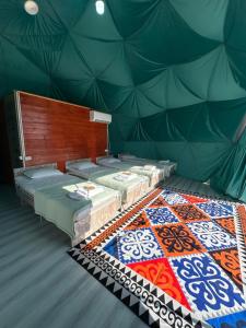 a room with four mattresses in a tent at Meykin Glamp in Cholpon-Ata +7 photos