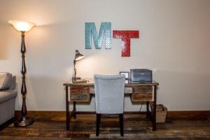 an office with a desk with a computer and a chair at Baker Loft 203 in Whitefish