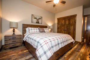 a bedroom with a bed and a ceiling fan at Baker Loft 203 in Whitefish