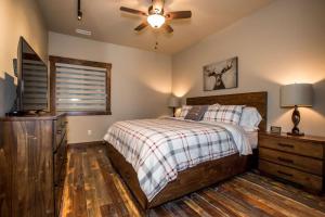 a bedroom with a bed and a ceiling fan at Baker Loft 203 in Whitefish