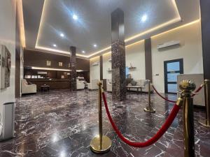 a lobby with a red rope in the middle of a room at وتد الشرق للشقق المخدومة in Khafji