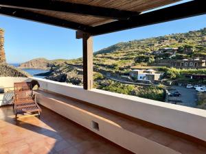 a balcony with a view of a river and mountains at Dammuso Ziloto - Cala Levante & Arco dell'Elefante in Pantelleria