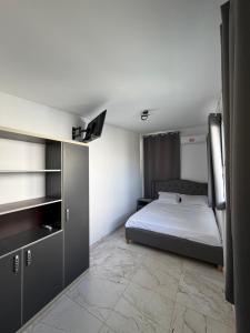 a bedroom with a bed and a tv on the wall at Sea view Kastri in Nei Poroi
