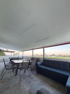 a living room with a couch and tables and chairs at Sea view Kastri in Nei Poroi