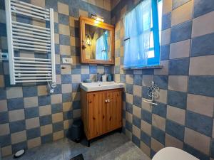 a bathroom with a sink and a mirror at Casa Histria Apartments in Šmarje +28 photos