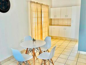 a kitchen with a table and chairs in a room at Arise self catering in Burgersfort +12 photos