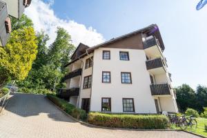 an apartment building in the middle of a street at Haus Sachsensteinblick in Bad Sachsa