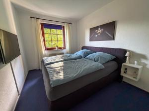 a small bedroom with a bed and a window at Haus Sachsensteinblick in Bad Sachsa
