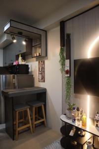 a kitchen with a bar and a table in a room at Plumera Mactan Bldg A 108 in Bankal
