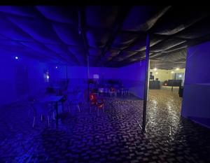 a room with a blue room with tables and chairs at Kings Hotel and Lounge in Bwari