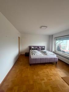 a bedroom with a bed and a wooden floor at Ferienunterkunft International A in Bad Harzburg