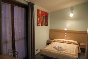 Posteľ alebo postele v izbe v ubytovaní Albergo Verdi
