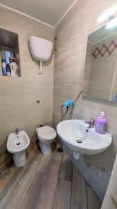 a bathroom with a sink and a toilet at Mare oltre in Castellammare di Stabia