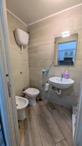 a bathroom with a toilet and a sink at Mare oltre in Castellammare di Stabia