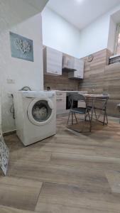 a kitchen with a washing machine and a table at Mare oltre in Castellammare di Stabia +51 photos