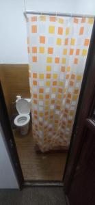 a bathroom with a toilet and a wall at D&ATurism in Prăjila