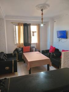 a living room with two couches and a table at Aïn turk oran in Aïn El Turk