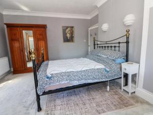 a bedroom with two beds and a mirror at Ferncliffe in Morecambe