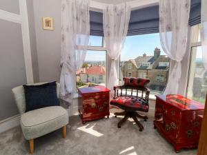 a living room with a chair and a window at Ferncliffe in Morecambe