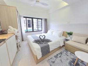 a bedroom with a bed with a towel on it at 1001 Stars Hotel in Ho Chi Minh City