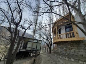 a house with a balcony on the side of it at Cloud Nine And A Half in Hunza Valley