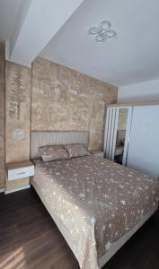a bedroom with a bed and a ceiling at Stan apartman Kolašin in Kolašin