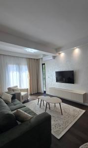 a living room with a couch and a table at Stan apartman Kolašin in Kolašin