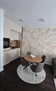 a dining room with a wooden table and chairs at Stan apartman Kolašin in Kolašin