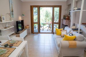 a living room with a couch and a table at Halkidiki Kassandra villa 3P Exclusive Peace & Beautiful Sea Views in Agia Paraskevi