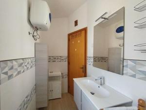 a bathroom with a sink and a mirror at Maison di Mario in Tresnuraghes +23 photos