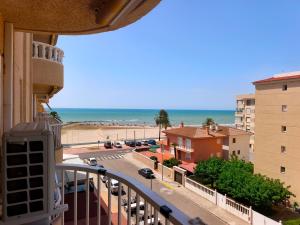 a view of the beach from the balcony of a building at Front beach apartment in Torreblanca