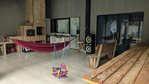 a room with a hammock in the middle of a room at Sitio ALI in Cachoeira Paulista