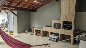 a room with a hammock in a room with motorcycles at Sitio ALI in Cachoeira Paulista