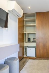 a living room with a tv and some shelves at 3Encostas in Cabeceiras de Basto