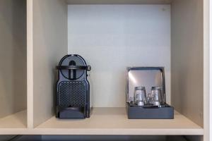 a shelf with a black blender and a mirror at 3Encostas in Cabeceiras de Basto
